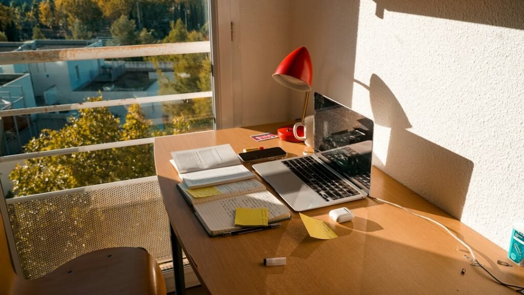 Writer using a laptop at a desk to draft and edit an article with AI writing assistance
