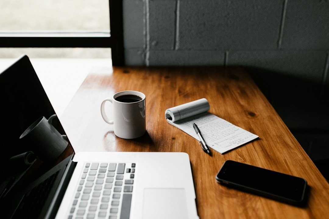Notebook, laptop and workspace used to plan and edit written content