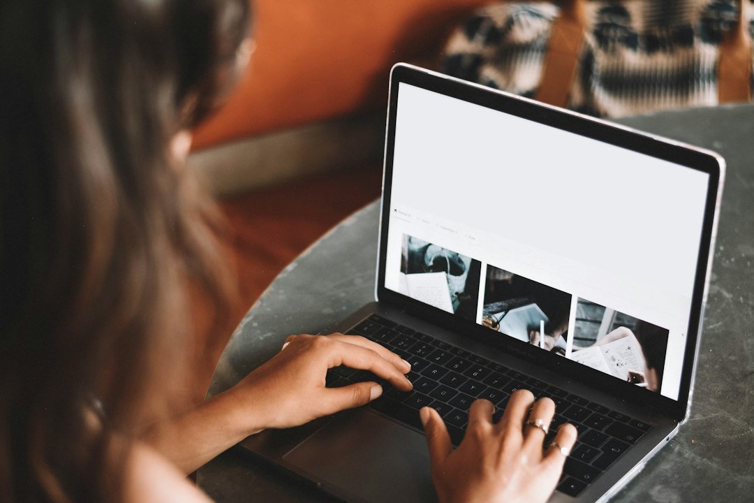 Freelancer reviewing work on a laptop at a home office desk